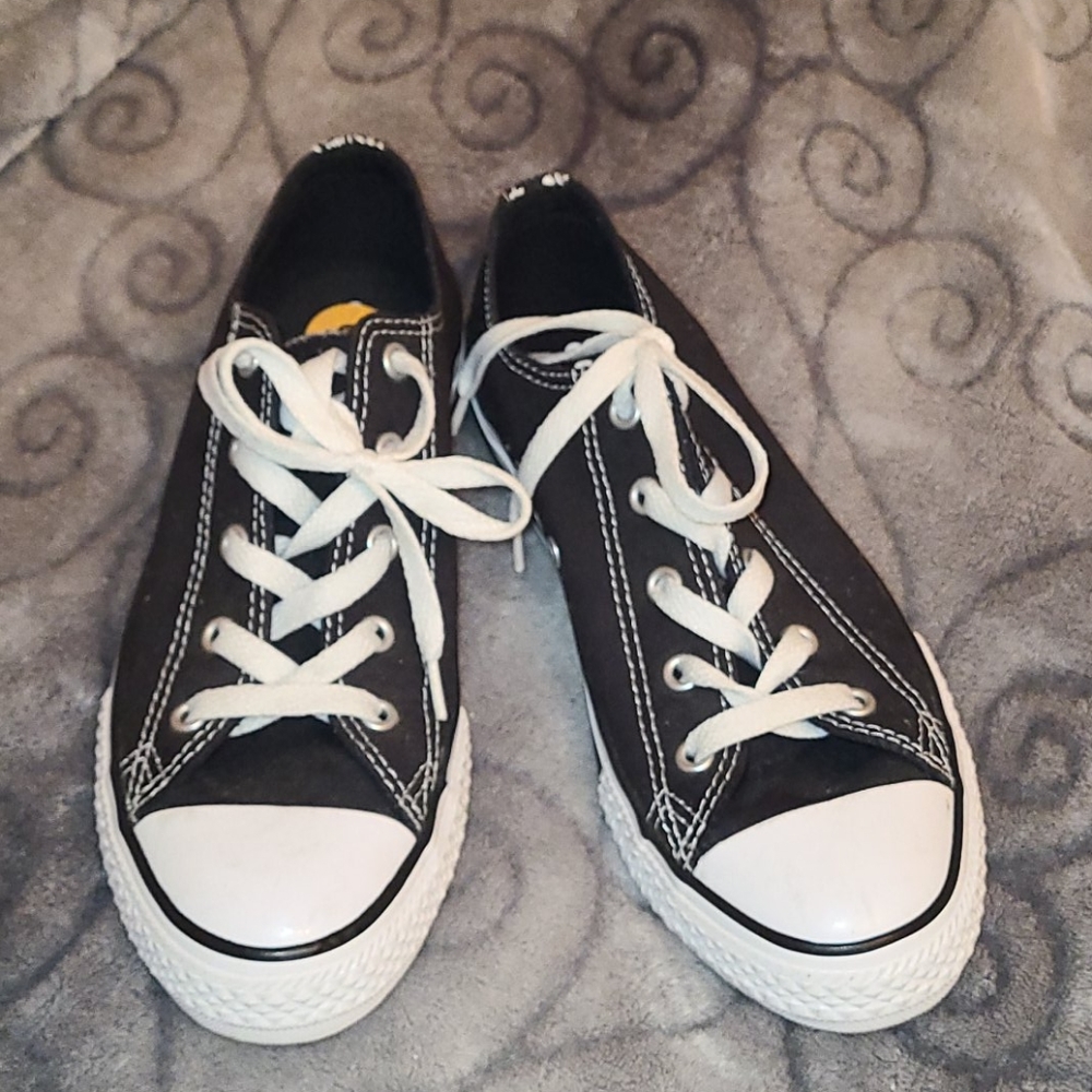 Black and white low top Converse.